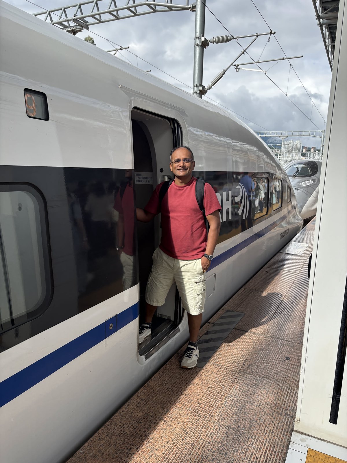 Mital boarding the high-speed train at Dali